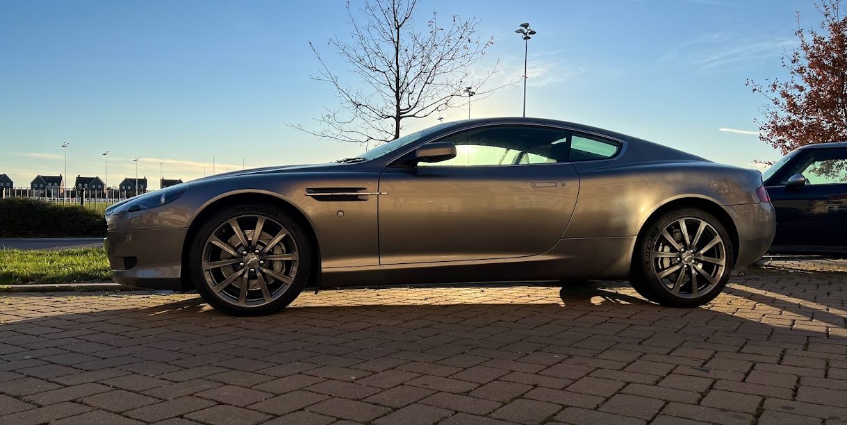 Aston Martin DB9 side profile in golden-hour light
